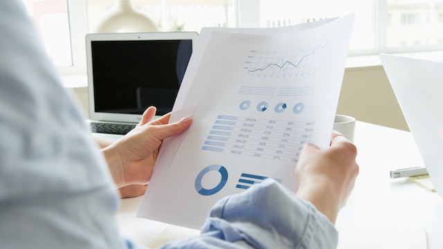 person holding financial documents